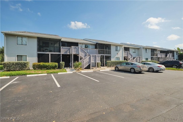 1051 Palm Ave Unit 117, North Fort Myers, FL 33903 - view of property featuring uncovered parking, stairs, and a residential view