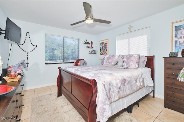 1051 Palm Ave Unit 117, North Fort Myers, FL 33903 - bedroom with light tile patterned flooring, ceiling fan, and baseboards