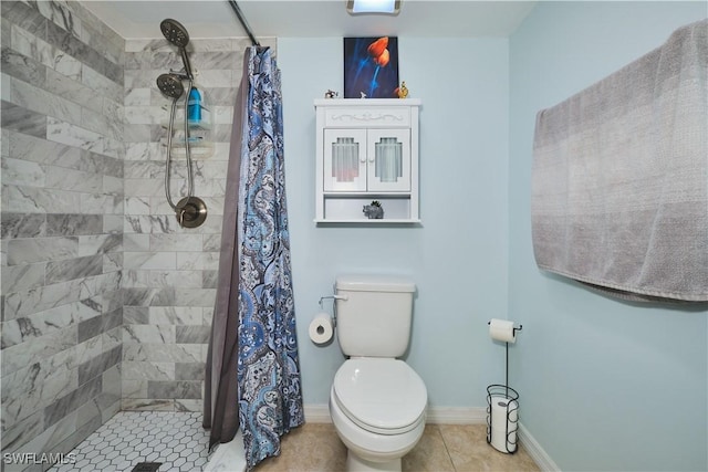 1051 Palm Ave Unit 117, North Fort Myers, FL 33903 - bathroom featuring a stall shower, toilet, tile patterned floors, and baseboards