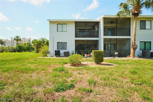1051 Palm Ave Unit 117, North Fort Myers, FL 33903 - back of house featuring a sunroom, a ceiling fan, a yard, and cooling unit