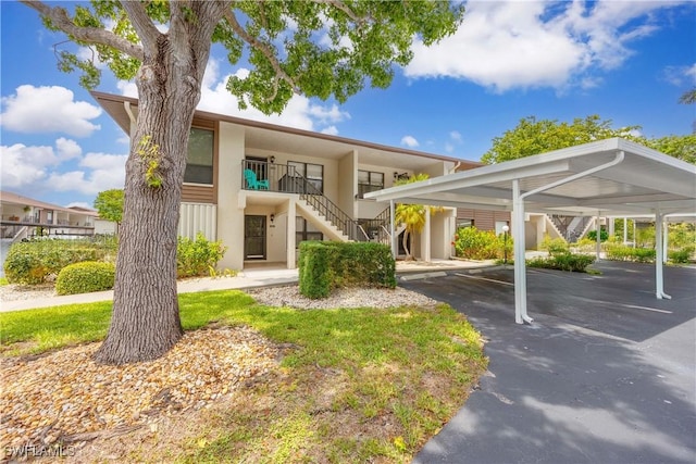 4241 Chantelle Dr Unit D201, Naples, FL 34112 - view of front facade with stairs and covered parking