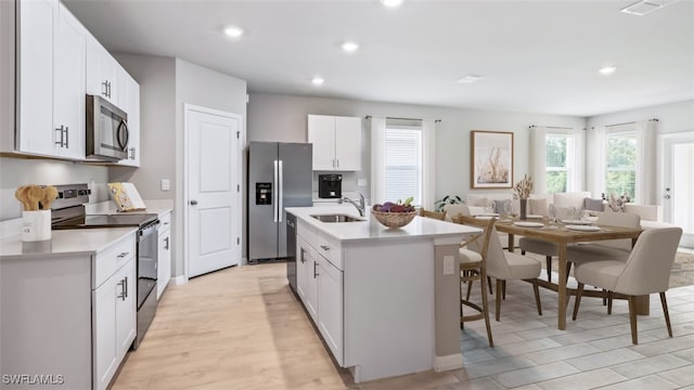 4135 Peaceful River Ln, Fort Myers, FL 33905 - kitchen with stainless steel appliances, a sink, light countertops, healthy amount of natural light, and recessed lighting