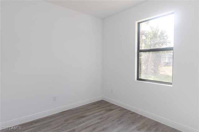 8048 Sherwood Cir, Labelle, FL 33935 - unfurnished room featuring wood finished floors and baseboards