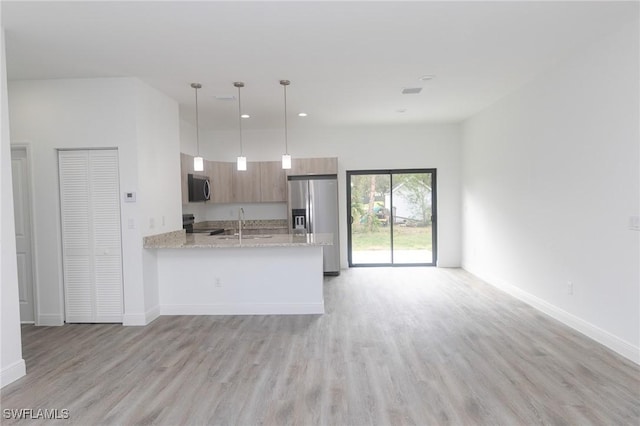8048 Sherwood Cir, Labelle, FL 33935 - kitchen featuring stainless steel appliances, light wood-type flooring, open floor plan, a sink, and baseboards