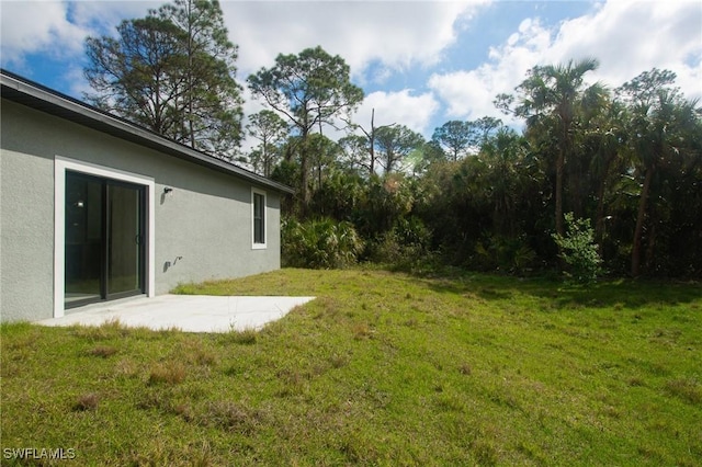8048 Sherwood Cir, Labelle, FL 33935 - view of grassy yard with a patio