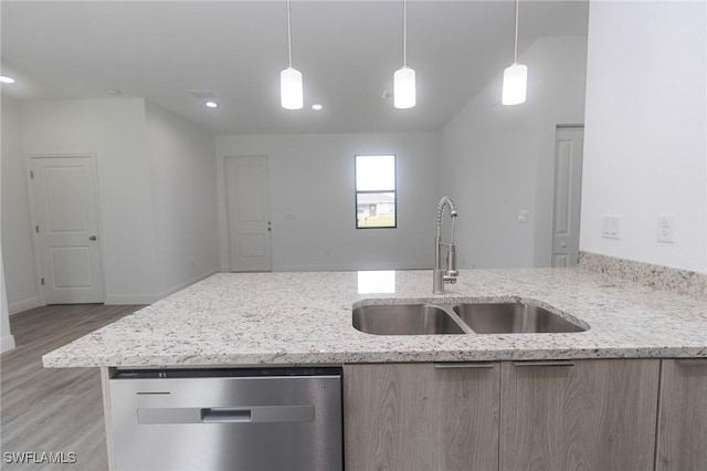 8048 Sherwood Cir, Labelle, FL 33935 - kitchen with a sink, stainless steel dishwasher, light wood finished floors, light stone countertops, and light brown cabinetry