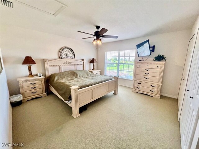 19915 Lake Vista Cir Unit 15C, Lehigh Acres, FL 33936 - bedroom featuring baseboards, light carpet, and a ceiling fan