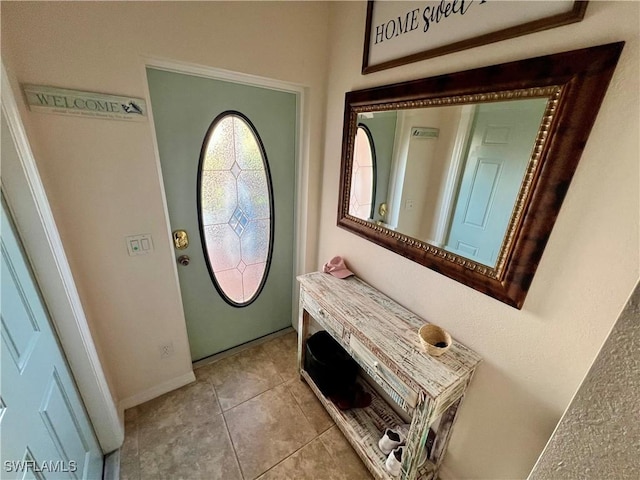 19915 Lake Vista Cir Unit 15C, Lehigh Acres, FL 33936 - entrance foyer featuring light tile patterned floors and baseboards
