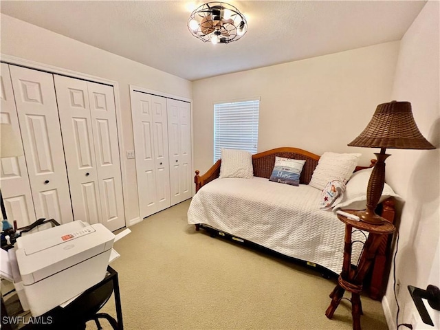 19915 Lake Vista Cir Unit 15C, Lehigh Acres, FL 33936 - bedroom with multiple closets and carpet floors