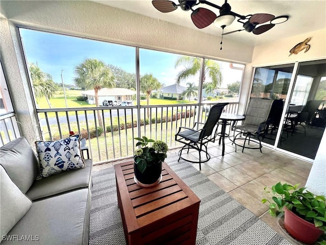 19915 Lake Vista Cir Unit 15C, Lehigh Acres, FL 33936 - sunroom with a ceiling fan, plenty of natural light, and a residential view