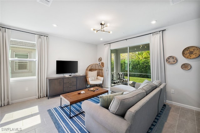 4665 Arboretum Cir Unit 101, Naples, FL 34112 - living room with light tile patterned floors, a chandelier, baseboards, and recessed lighting