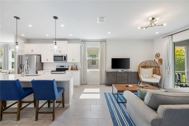 4665 Arboretum Cir Unit 101, Naples, FL 34112 - living area with recessed lighting, light tile patterned floors, and a chandelier