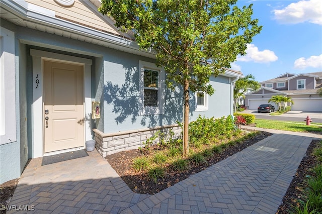 4665 Arboretum Cir Unit 101, Naples, FL 34112 - view of exterior entry featuring stucco siding