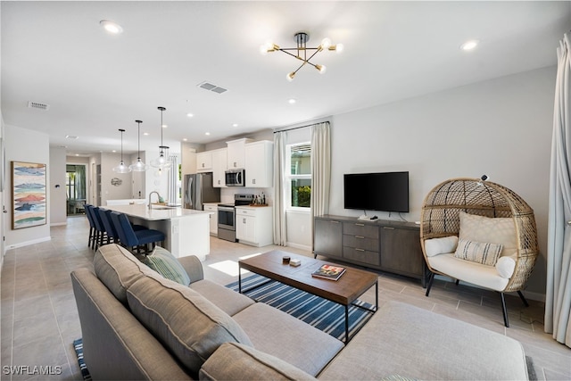 4665 Arboretum Cir Unit 101, Naples, FL 34112 - living area featuring a chandelier, recessed lighting, and baseboards