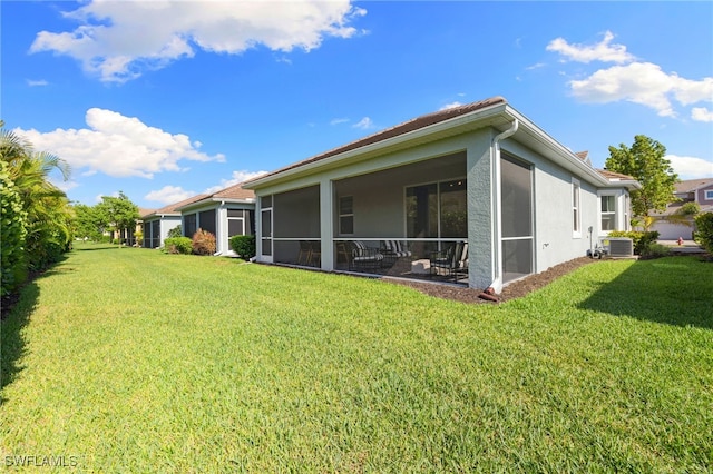 4665 Arboretum Cir Unit 101, Naples, FL 34112 - back of property with stucco siding, a lawn, a sunroom, and central AC unit