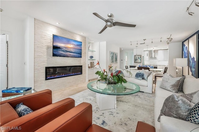 786 109th Ave N, Naples, FL 34108 - living room with a ceiling fan, a fireplace, track lighting, and built in shelves