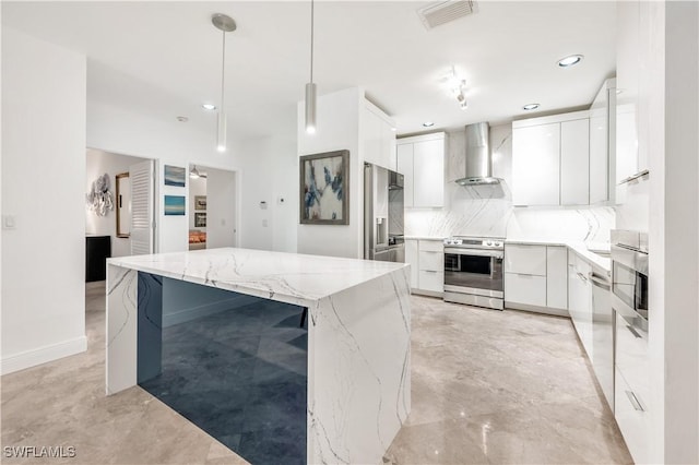 786 109th Ave N, Naples, FL 34108 - kitchen featuring appliances with stainless steel finishes, wall chimney exhaust hood, modern cabinets, decorative backsplash, and white cabinetry