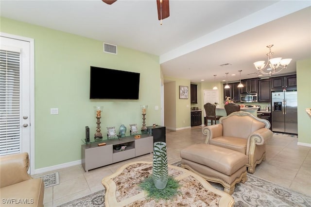 8570 Evernia Ct Unit 101, Estero, FL 34135 - living area with light tile patterned floors, a chandelier, ceiling fan, and baseboards