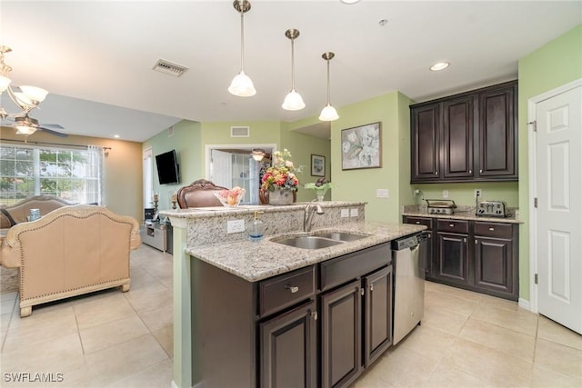 8570 Evernia Ct Unit 101, Estero, FL 34135 - kitchen with a sink, dishwasher, open floor plan, light tile patterned floors, and dark brown cabinetry