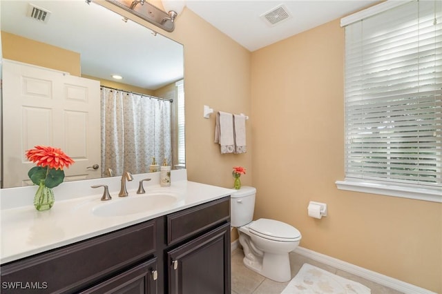 8570 Evernia Ct Unit 101, Estero, FL 34135 - full bath featuring vanity, toilet, healthy amount of natural light, and tile patterned flooring