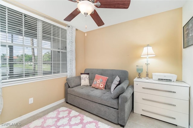8570 Evernia Ct Unit 101, Estero, FL 34135 - living area featuring light tile patterned floors, ceiling fan, and baseboards