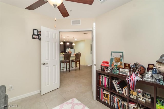 8570 Evernia Ct Unit 101, Estero, FL 34135 - living area with tile patterned floors, ceiling fan, and baseboards