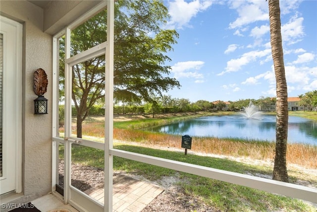 8570 Evernia Ct Unit 101, Estero, FL 34135 - unfurnished sunroom with a water view and a textured wall