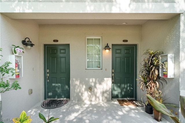 8570 Evernia Ct Unit 101, Estero, FL 34135 - view of exterior entry featuring stucco siding and a porch