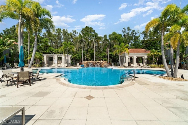 8570 Evernia Ct Unit 101, Estero, FL 34135 - community pool featuring a patio area and view of scattered trees