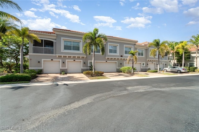 8570 Evernia Ct Unit 101, Estero, FL 34135 - townhome / multi-family property featuring stucco siding, a tiled roof, an attached garage, and driveway