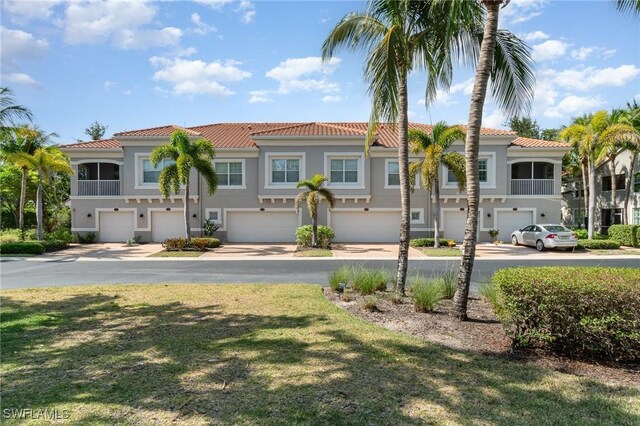 8570 Evernia Ct Unit 101, Estero, FL 34135 - multi unit property with a tiled roof, a garage, and stucco siding