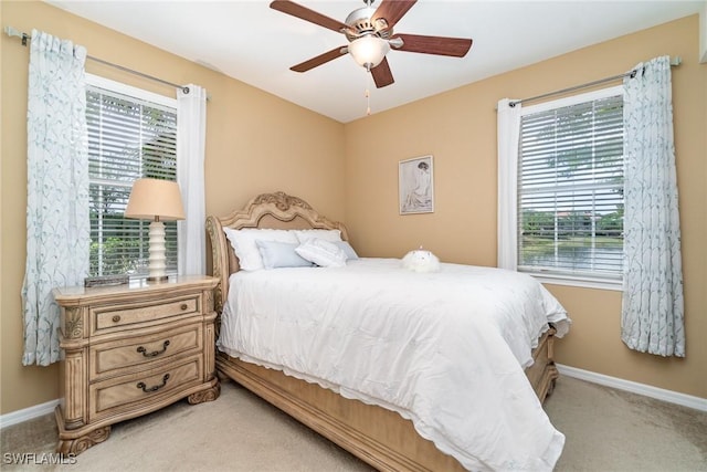 8570 Evernia Ct Unit 101, Estero, FL 34135 - bedroom with light colored carpet, baseboards, and ceiling fan