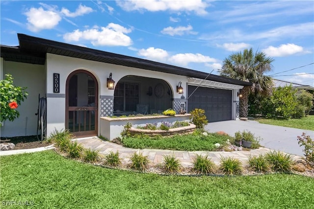 3500 Liberty St, Port Charlotte, FL 33948 - view of front of house with stucco siding, an attached garage, concrete driveway, a front yard, and a porch