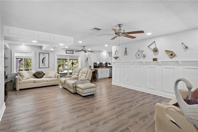 3500 Liberty St, Port Charlotte, FL 33948 - living area featuring ceiling fan, light wood-style floors, recessed lighting, and a textured ceiling