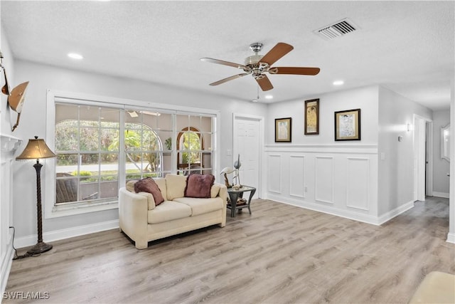 3500 Liberty St, Port Charlotte, FL 33948 - living room featuring a ceiling fan, baseboards, light wood-style floors, a textured ceiling, and recessed lighting