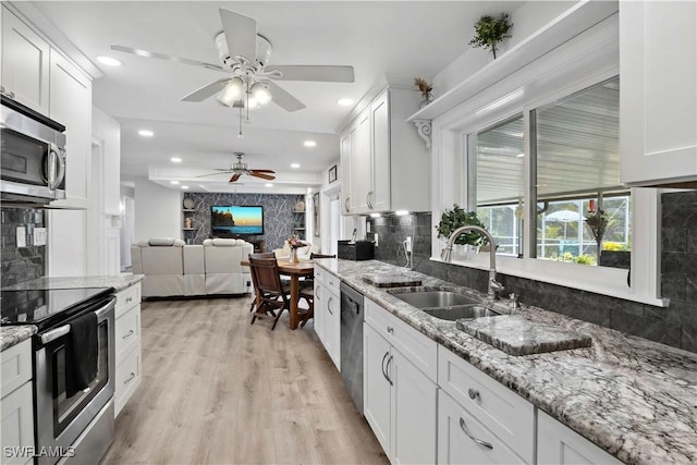 3500 Liberty St, Port Charlotte, FL 33948 - kitchen with a sink, stainless steel appliances, a ceiling fan, tasteful backsplash, and recessed lighting