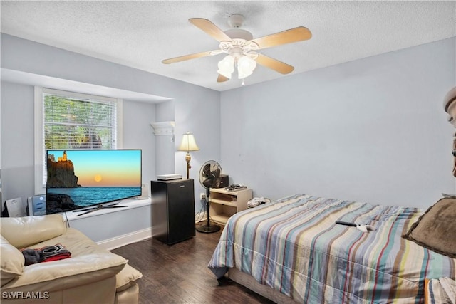 3500 Liberty St, Port Charlotte, FL 33948 - bedroom with dark wood finished floors, a textured ceiling, baseboards, and ceiling fan
