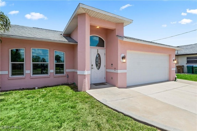 923 SW 4th Pl, Cape Coral, FL 33991 - view of front of house with stucco siding, a garage, and driveway