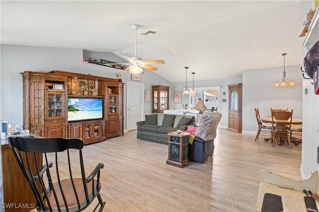 923 SW 4th Pl, Cape Coral, FL 33991 - living area featuring light wood-style flooring, vaulted ceiling, a ceiling fan, a chandelier, and baseboards