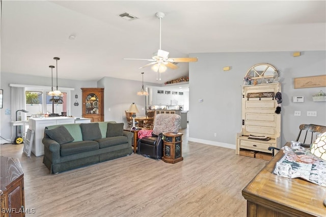 923 SW 4th Pl, Cape Coral, FL 33991 - living area with a ceiling fan, light wood-style flooring, lofted ceiling, and baseboards