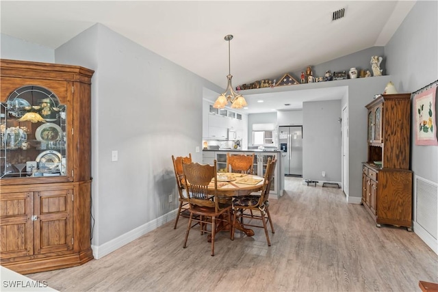 923 SW 4th Pl, Cape Coral, FL 33991 - dining room with light wood-style floors, baseboards, and lofted ceiling