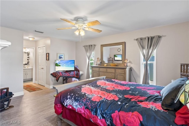 923 SW 4th Pl, Cape Coral, FL 33991 - bedroom featuring wood finished floors, connected bathroom, ceiling fan, and baseboards