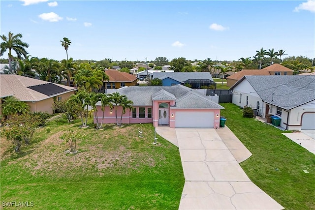 923 SW 4th Pl, Cape Coral, FL 33991 - view of front of home with a residential view, an attached garage, concrete driveway, and a front lawn
