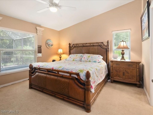 15137 Cortona Way, Naples, FL 34120 - bedroom with light colored carpet, multiple windows, baseboards, and ceiling fan