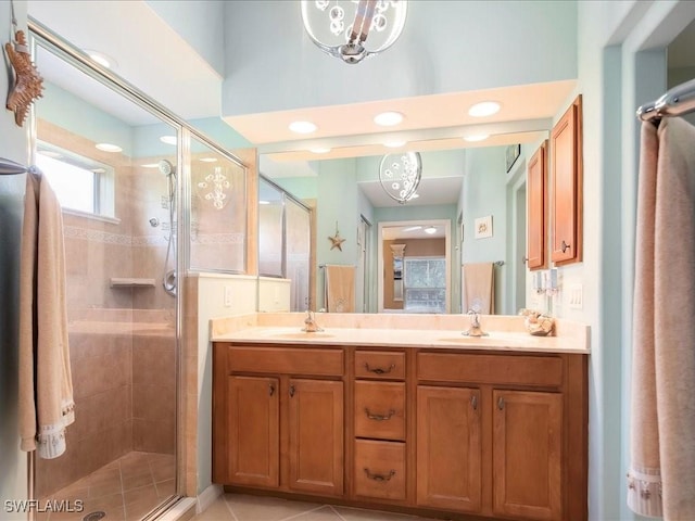 15137 Cortona Way, Naples, FL 34120 - bathroom featuring a stall shower and double vanity