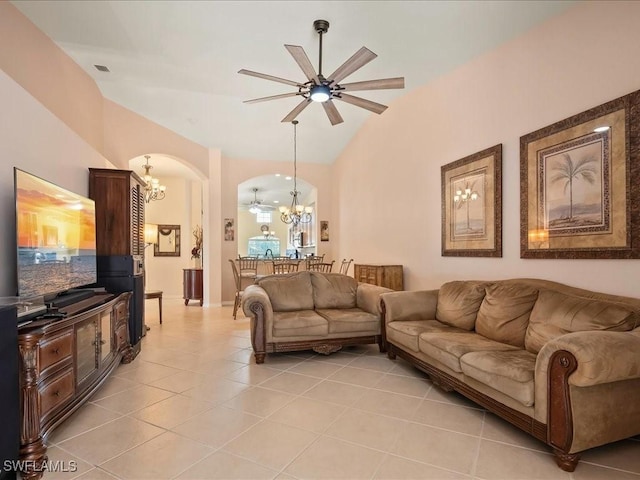 15137 Cortona Way, Naples, FL 34120 - living room with a chandelier, arched walkways, lofted ceiling, a ceiling fan, and light tile patterned floors