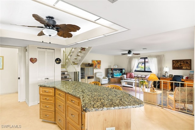 27771 Hacienda E Blvd Unit 223A, Bonita Springs, FL 34135 - kitchen with ceiling fan, stone countertops, open floor plan, a kitchen island, and light tile patterned floors