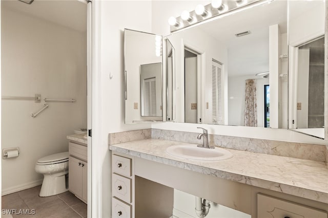 27771 Hacienda E Blvd Unit 223A, Bonita Springs, FL 34135 - bathroom featuring vanity, toilet, tile patterned floors, and baseboards