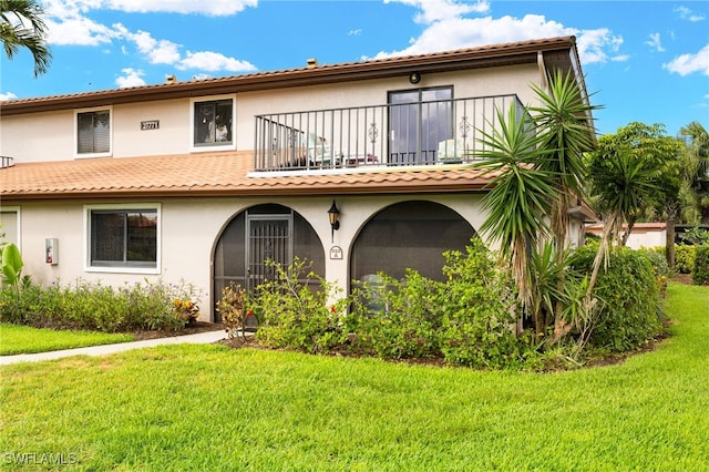 27771 Hacienda E Blvd Unit 223A, Bonita Springs, FL 34135 - back of property with a balcony, stucco siding, and a yard