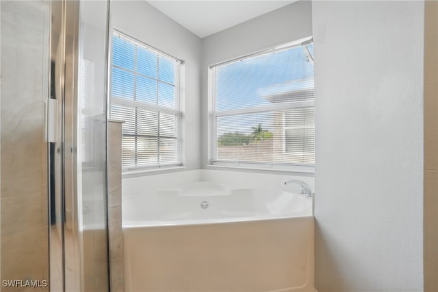 8888 Falcon Pointe Loop, Fort Myers, FL 33912 - bathroom with a bath and a shower with shower door